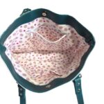 inside of tote bag with colorful puppies and teal accents
