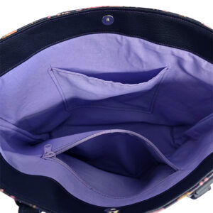 tote bag featuring colorful flowers with black accent and purple lining. handmade with faux leather