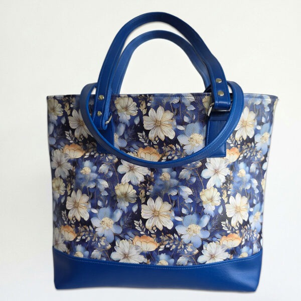 tote bag featuring blue, cream and peach flowers with flowers and blue accents. handmade with faux leather