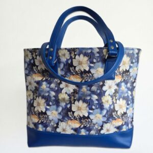 tote bag featuring blue, cream and peach flowers with flowers and blue accents. handmade with faux leather